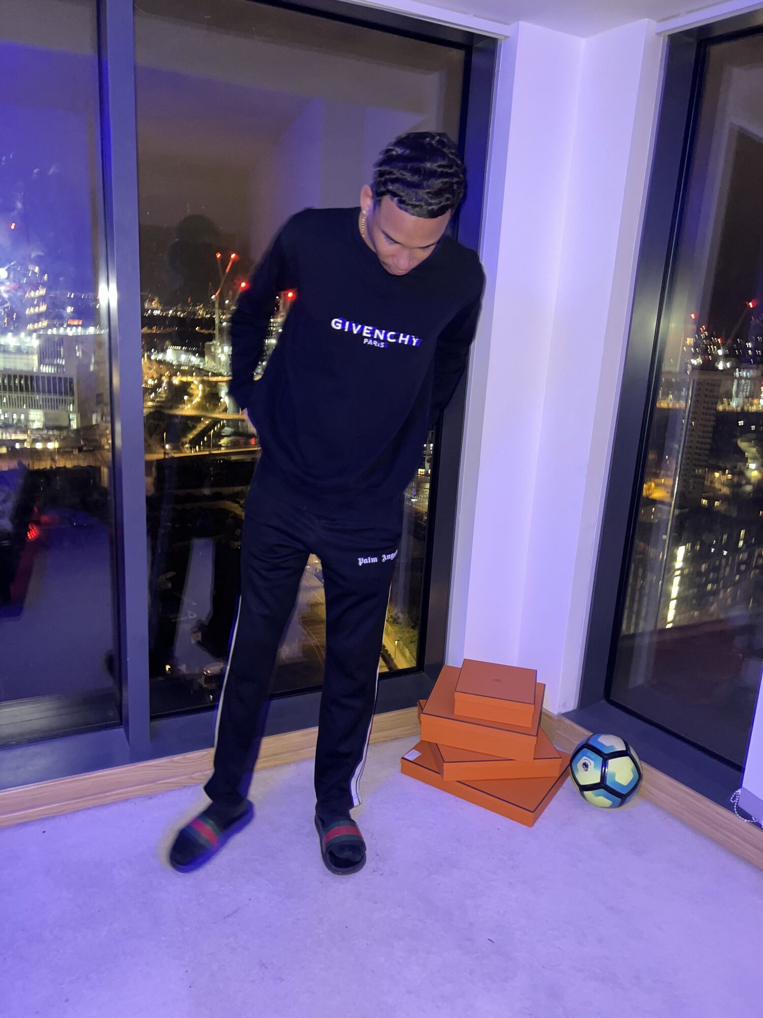 Joshua Arthur (JJDREAMSS) — Waves, a football and Givenchy against the skyline