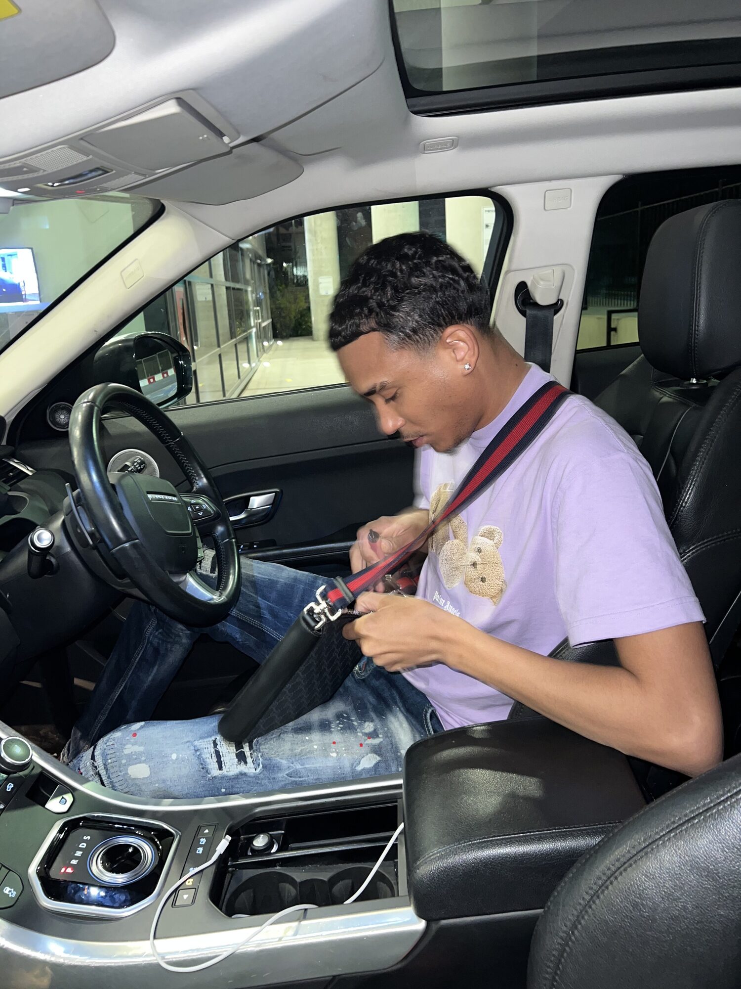 Joshua Arthur (JJDREAMSS) — Sat in the Range Rover — purple Palm Angels, DSquared2 jeans, Gucci messenger