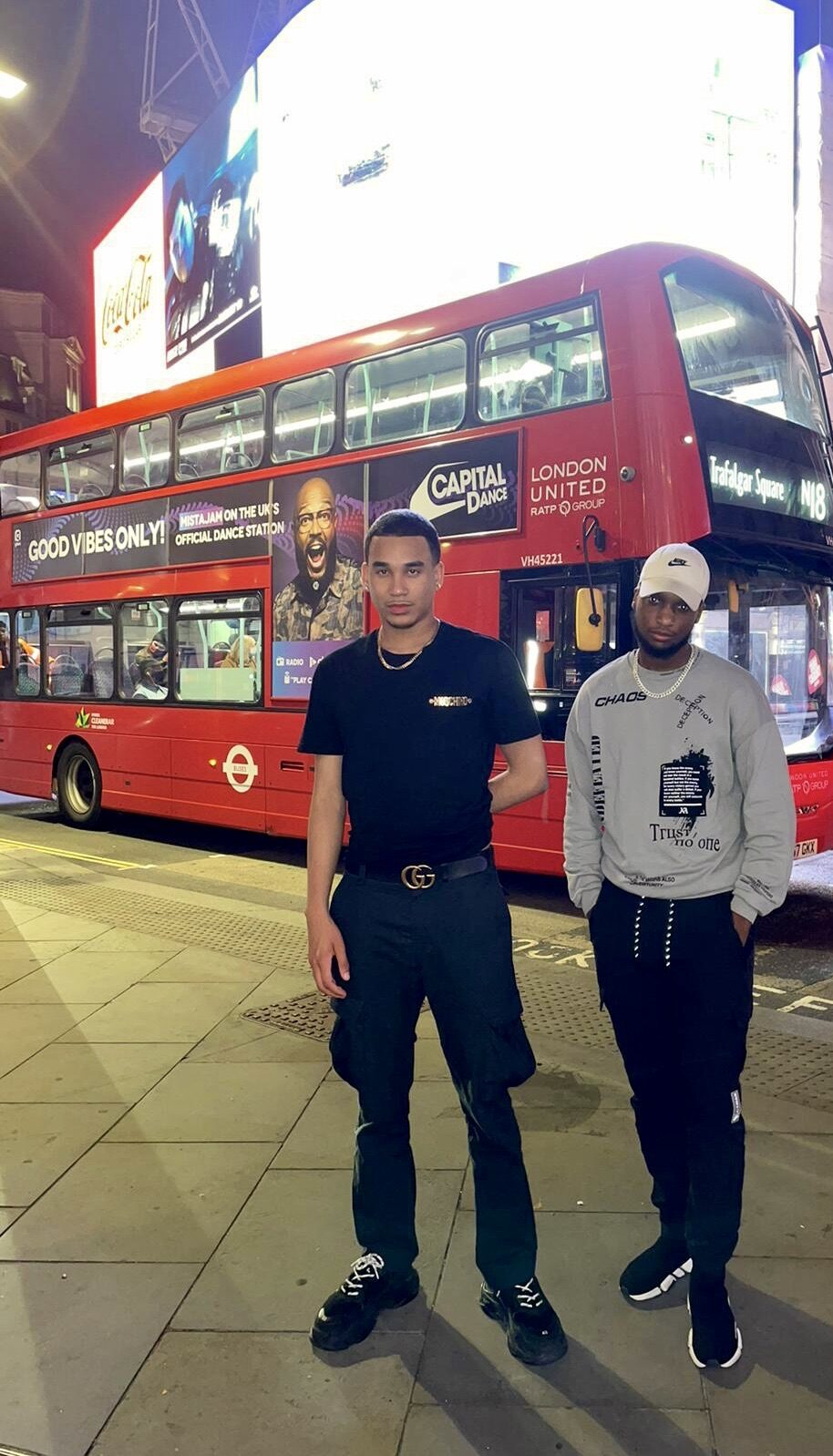 Joshua Arthur (JJDREAMSS) · London — Possibly the most London photograph in the archive: Moschino, Balenciaga, a red bus, Piccadilly Circus
