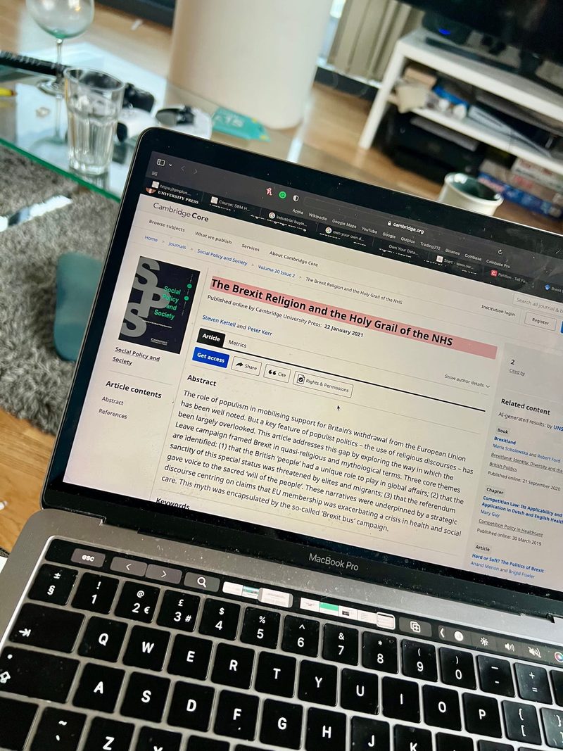 Joshua Arthur researching NHS policy on Cambridge Core academic journal MacBook Pro The Brexit Religion Holy Grail of the NHS 2023 evaluator North East London